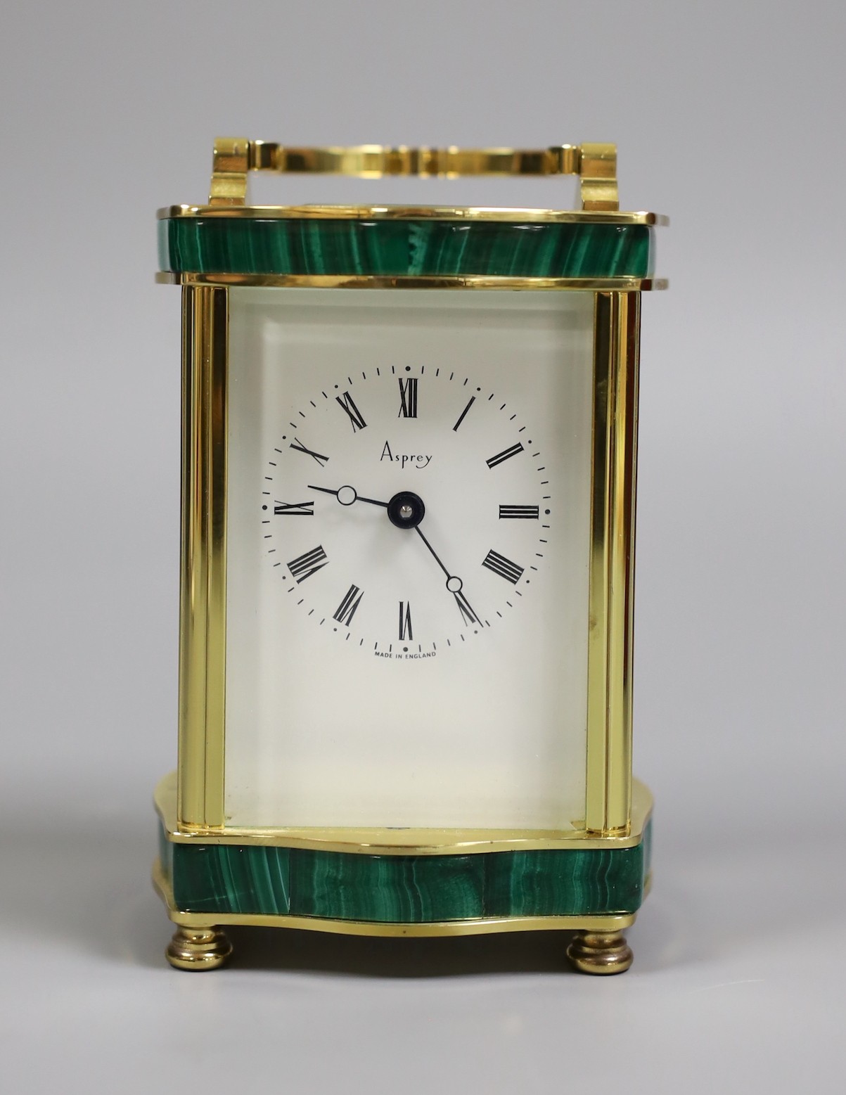 An Asprey carriage timepiece with key, 12 cms high, and an Asprey presentation box